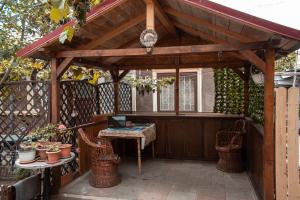 a wooden pergola with a table on a patio at Victor Residence 38 in Bucharest