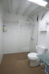 a bathroom with a white toilet and a table at La Casina de Carcaboso in Carcaboso