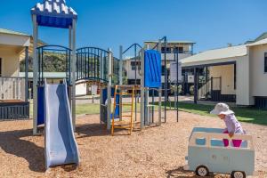 a child playing in a playground with a toy cart at E.V. - Eurong Beach Villa in K'gari Island (Fraser Island)