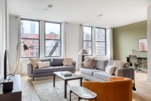 a living room with a couch and a table at Soho 3br w wd elevator nr cafes restaurants NYC-1043 in New York