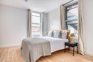 a white bedroom with a bed and a window at Soho 3br w wd elevator nr cafes restaurants NYC-1043 in New York