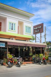 a group of motorcycles parked in front of a building at Phangan Barsay Hostel in Thongsala