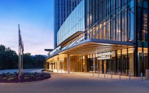 a large glass building with a flag in front of it at InterContinental Tashkent, an IHG Hotel in Tashkent