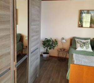 a room with a bed and a sliding door at Au Piémont des Vosges in Gertwiller