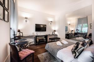 a living room with two beds and a flat screen tv at Premium Apart Varsovia Alice 2 in Warsaw
