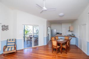 a kitchen and dining room with a table and chairs at E.V. - Eurong Beach Villa in K'gari Island (Fraser Island)