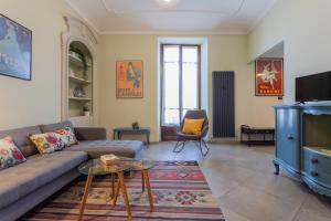 a living room with a couch and a tv at Casa Dora by Wonderful Italy in Turin