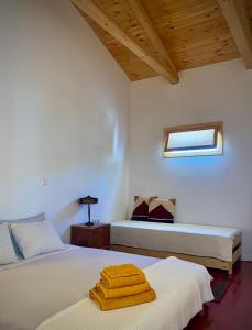 a bedroom with two beds with towels on them at Lichada Villa's in Likhás