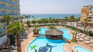 an aerial view of a resort with a pool and the ocean at Golden Taurus Aquapark Resort in Pineda de Mar