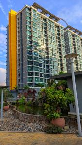 a large apartment building with a pond in front of it at Rafa Vista Alam Homestay in Shah Alam +11 photos