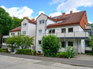 a white house with a red roof on a street at Nice Apartment in Marburg in Marburg an der Lahn