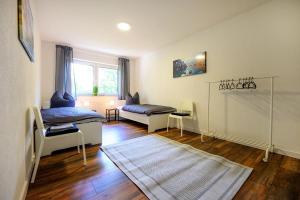 a living room with two beds and a rug at Nice Apartment in Marburg in Marburg an der Lahn
