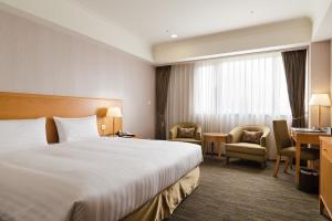 Postel nebo postele na pokoji v ubytování Fushin Hotel Taipei