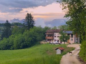 a house on a hill next to a dirt road at Dimora Grotta Azzurra in Tiago