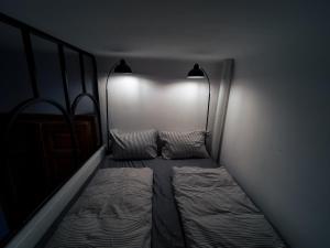 ein dunkles Zimmer mit 2 Betten und 2 Lampen in der Unterkunft Sincai 20 in Bistriţa