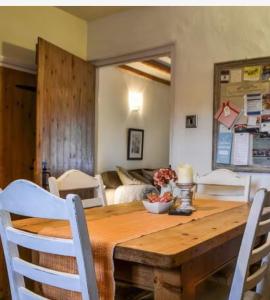 a dining room with a wooden table and chairs at Roses Cottage - near Scafell Comfy Modern Idyllic in Santon Bridge
