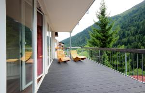 a balcony with two chairs and a view of a mountain at Villa Chiara in Sankt Anton am Arlberg
