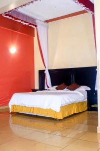 a bedroom with a bed with a canopy at Jamia Central Hotel in Nairobi