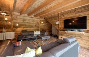 a living room with a couch and a flat screen tv at Villa Chiara in Sankt Anton am Arlberg