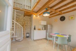 a kitchen and dining room with a table and chairs at La closeraie in Lantages