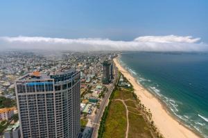 an aerial view of a beach and a tall building at Luxury Apartment in Da Nang