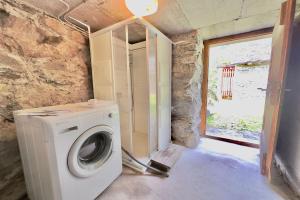 a washing machine in a room with a window at Rustico Savinera - Happy Rentals in San Carlo