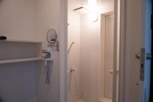 a bathroom with a shower with a hair dryer at HOTEL BOTH in Shari
