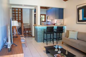 a living room with a couch and a kitchen at Meu Paraíso em Búzios - 70 metros da Praia in Búzios