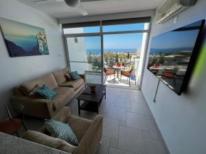 a living room with a couch and a table at Green Door Getaway in Limassol