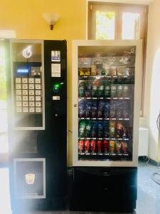 uma máquina de venda automática com bebidas e um refrigerador de bebidas em Villa Luzzatti em Roma