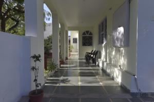 a hallway of a house with a table and chairs at N.K. Heritage by T.C. Group in Udaipur