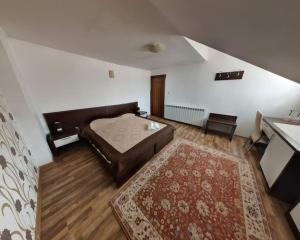 a large bedroom with a bed and a rug at Casa 1 Mai, Parcare in curte in Râmnicu Vâlcea
