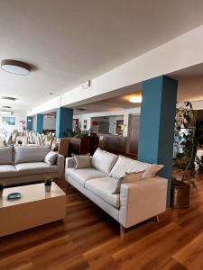 a living room with two couches and a table at PFA Hotel - Isola d'Elba in Cavo