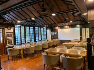 a large room with tables and chairs and a whiteboard at 奕青民宿-梅酒 梅精 法國麵包plum winery guesthouse in Shuili