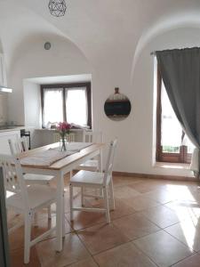 un comedor blanco con mesa y sillas en appartamento in Borgo storico., en Pontremoli