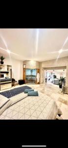 a large bedroom with a large bed in a room at Suite Privative Jacuzzi Sauna de la Villa Del Castagnol in Saint-Nexans