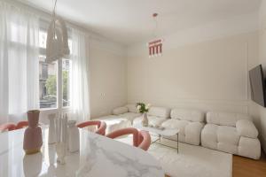a white living room with a white couch and a table at Loft in Acropolis in Athens