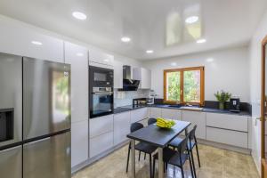 a kitchen with a table and some chairs in it at La Petite Chalautrière - Avec grand jardin in Chalautre-la-Petite