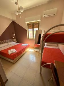 a bedroom with two bunk beds and a window at B&B Elegance in Villa San Giovanni