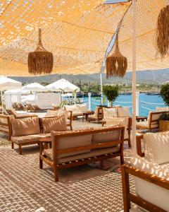 a patio with chairs and tables and umbrellas at Merit Park Hotel Casino & SPA in Kyrenia
