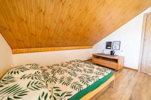 a bedroom with a bed and a wooden ceiling at Obiekt Wakacyjny Rejs in Mikołajki
