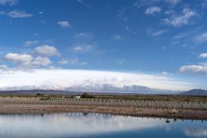 a view of a mountain range with a body of water at Villas Del Malbec Lodges in Agrelo