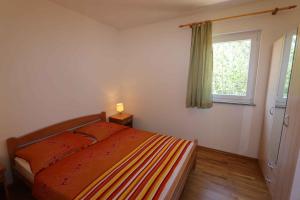 a bedroom with a bed and a window at Apartment in Silo/Insel Krk 13582 in Šilo