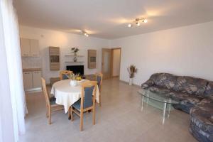 a living room with a table and a couch at Apartment in Silo/Insel Krk 13582 in Šilo