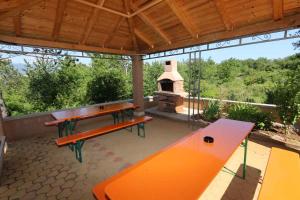 an outdoor patio with a picnic table and a stove at Apartment in Silo/Insel Krk 13582 in Šilo