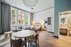 a hotel room with a bed and a table and chairs at Limehome Berlin Stresemannstr in Berlin +47 photos