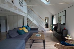 a living room with a couch and a table at La Quintessence - Amboise Hypercentre in Amboise