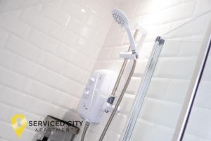 a shower in a bathroom with white tiles at SCA-Arden House 10min to NEC Sleeps 6 Parks 2 Vans in Coventry