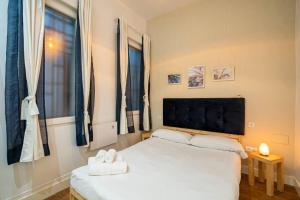 a bedroom with two beds and a large window at Chamberi - Quiet flat, ideal for families CAS in Madrid