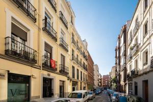 a city street with cars parked in front of buildings at Chamberi - Quiet flat, ideal for families CAS in Madrid